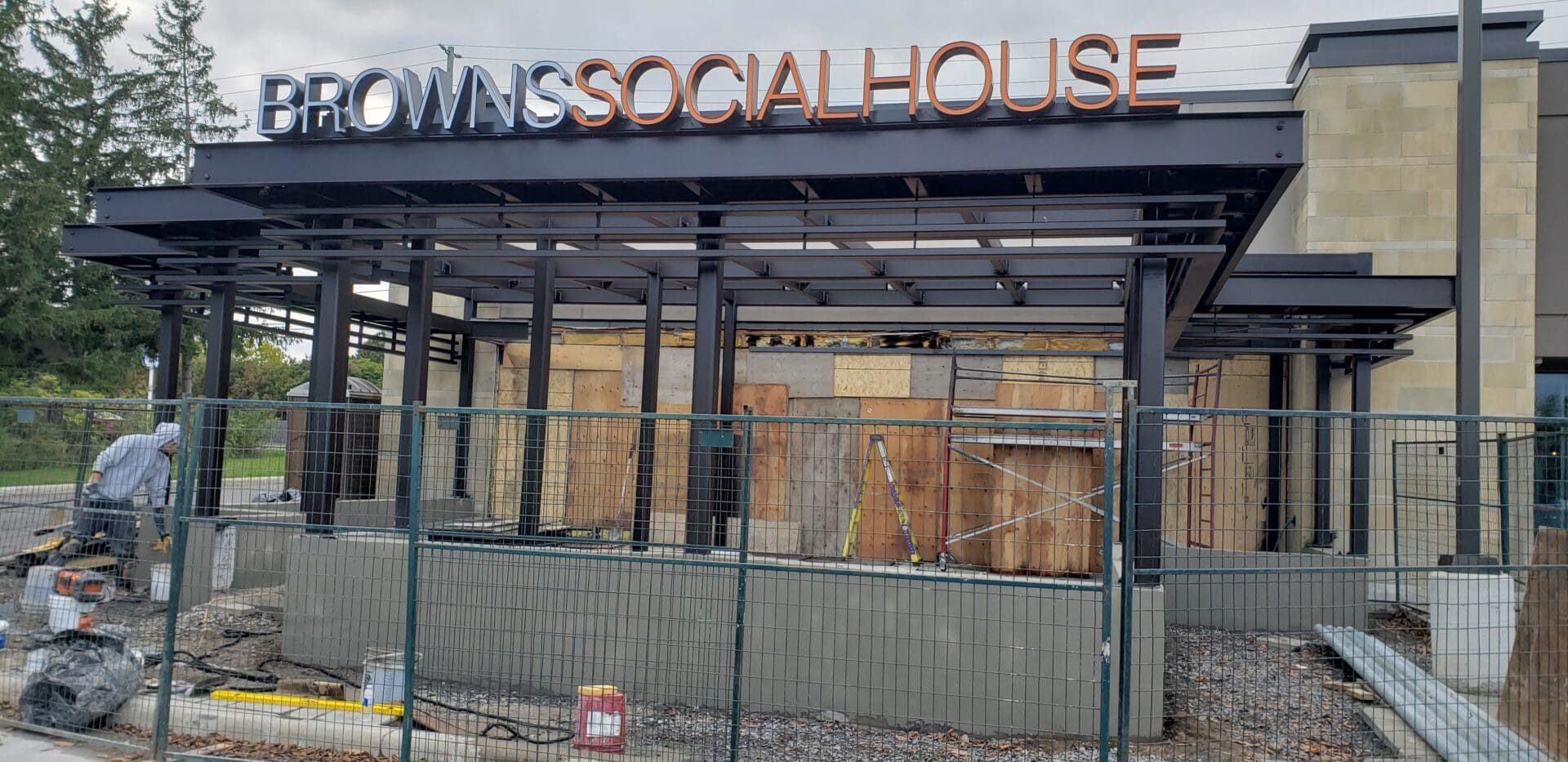 An under-construction Browns Social House structural closed off by black fences