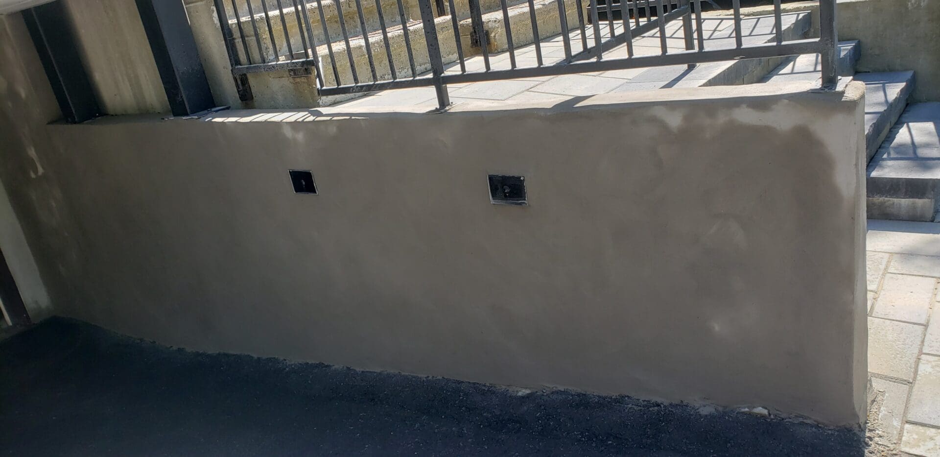A newly made cemented wall with an iron rod