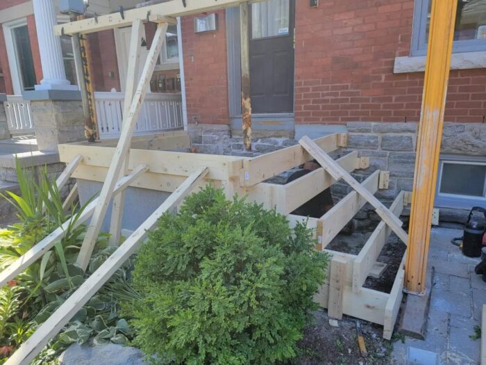 Step formwork built up against a brick wall