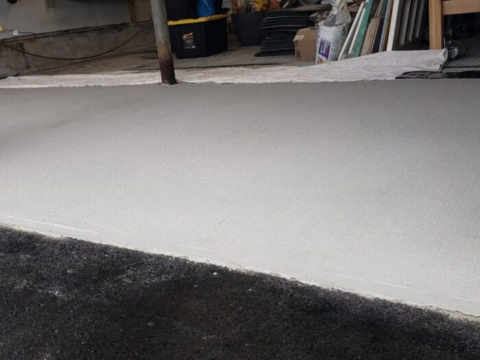 New concrete walkway running to the driveway