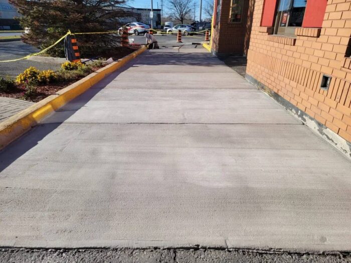 Poured concrete curing behind its forms
