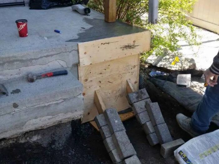 Poured concrete curing behind its forms