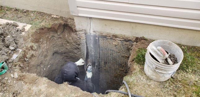 Exterior foundation wall exposed and sealed against water
