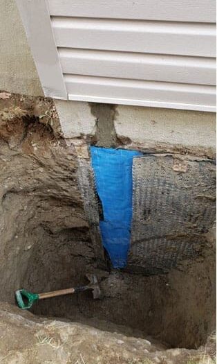 Foundation crack repaired and covered with waterproofing membrane