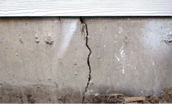 Close-up of a cracked foundation wall before repair