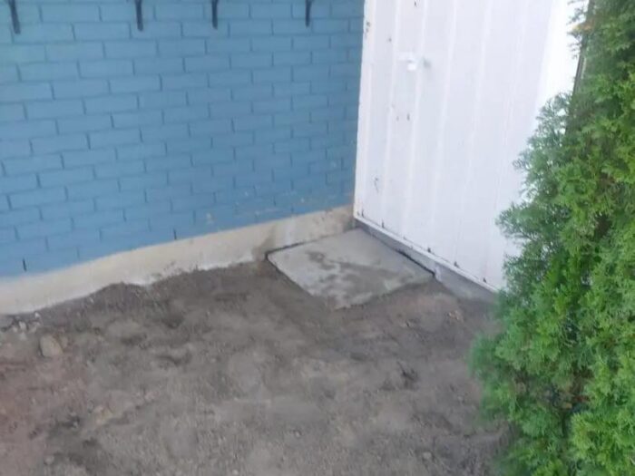 Foundation wall exposed and coated below grade