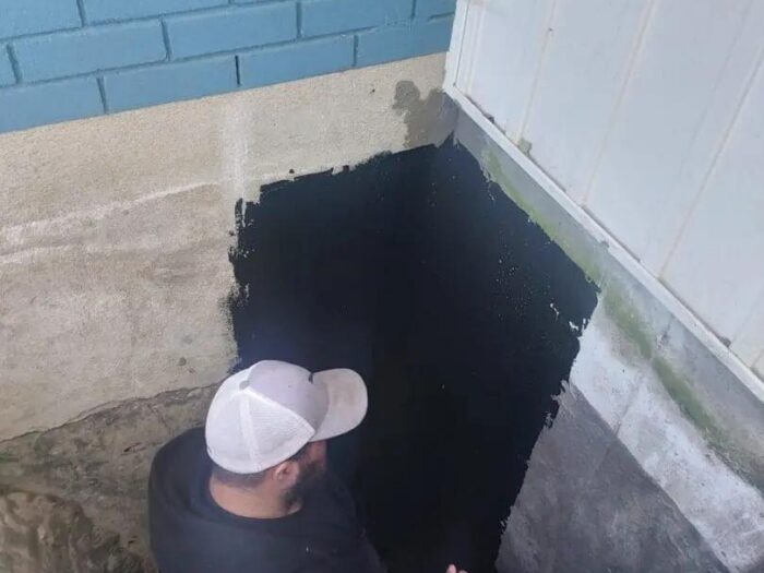 Working down the trench along an exposed foundation