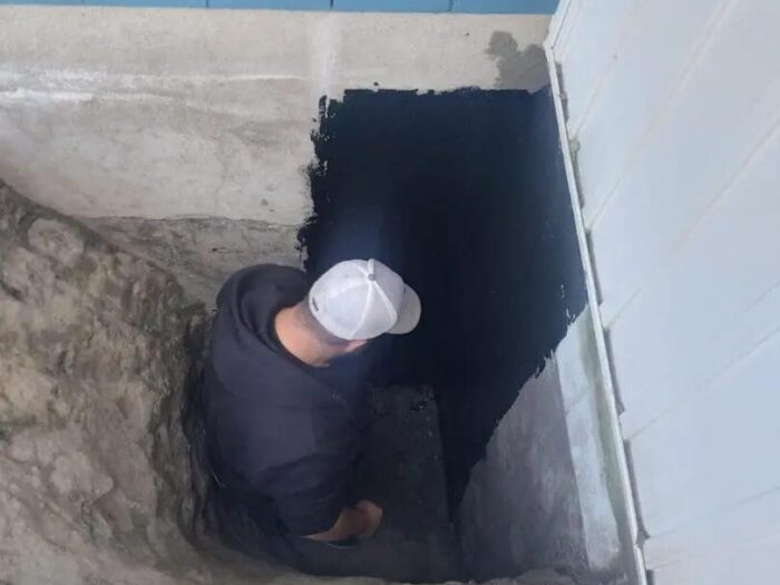 Sealing the base of a foundation wall from outside