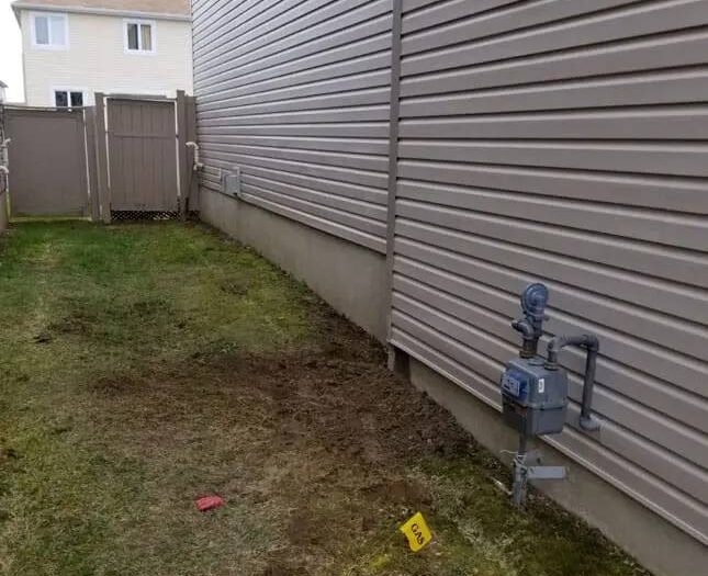 Foundation wall sealed and backfilled