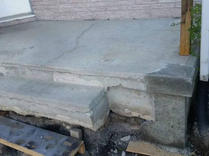 Settled concrete and a failed joint before repair