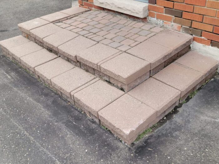 Paver step relaid level against the brick