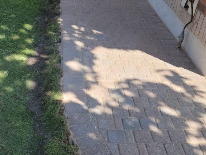 Interlock walkway re-levelled along the side of a house