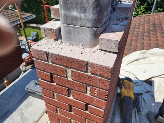 Chimney rebuild in progress with a new cap