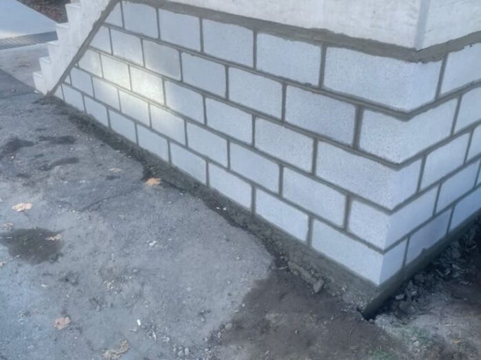 Painted block foundation wall after masonry repair