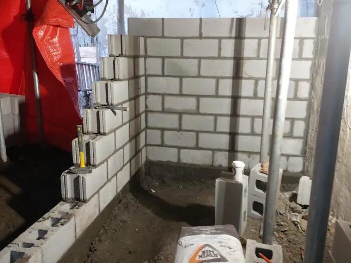 Block wall rebuilt under an existing structure