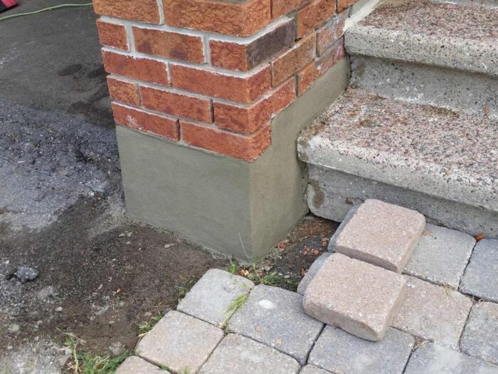 Brick pillar rebuilt beside a stone step