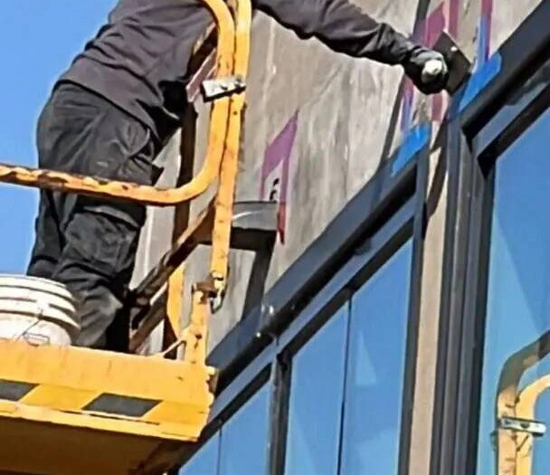 Working a commercial facade from a scissor lift