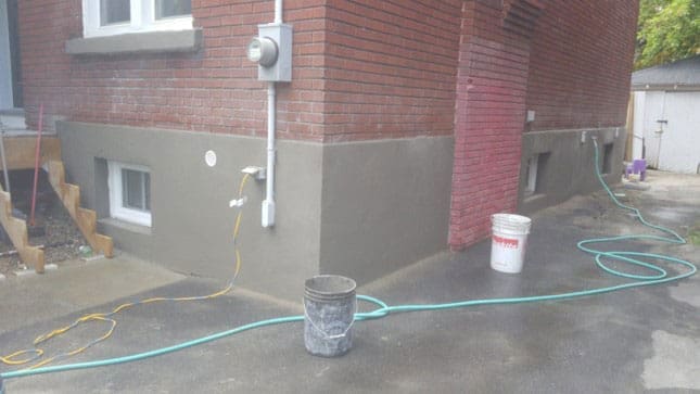 Freshly parged garage corner on an Ottawa home