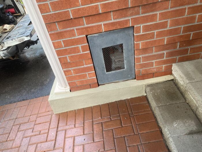 Parged foundation around a crawl-space vent