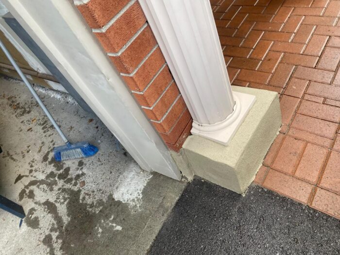 Parged column base beneath a porch post