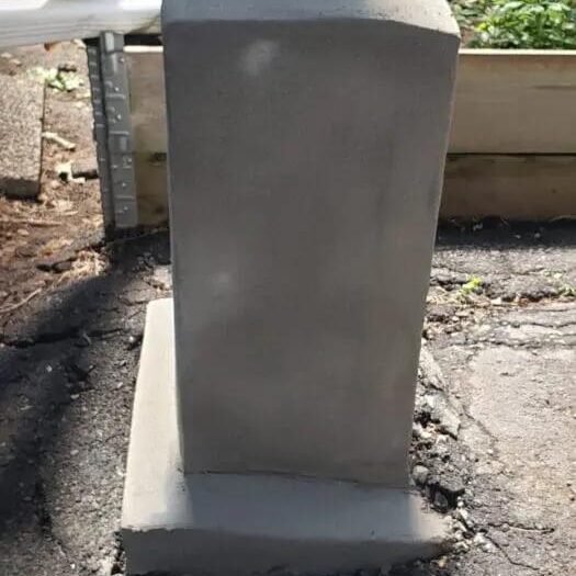Parged column base finished in smooth render