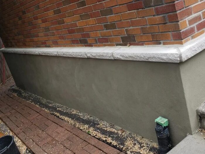Parged foundation along a deck edge