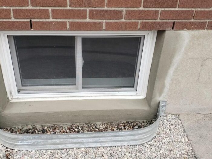 Parged wall finished around a basement window