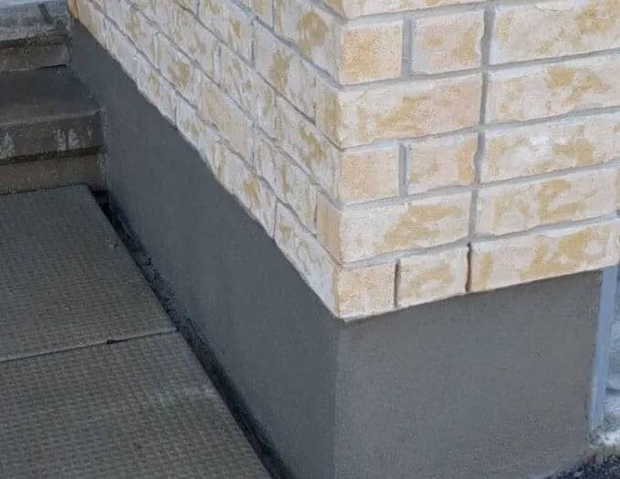 Finished parging along the exposed foundation of an Ottawa home
