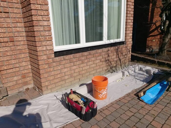 Parged foundation running the length of a house