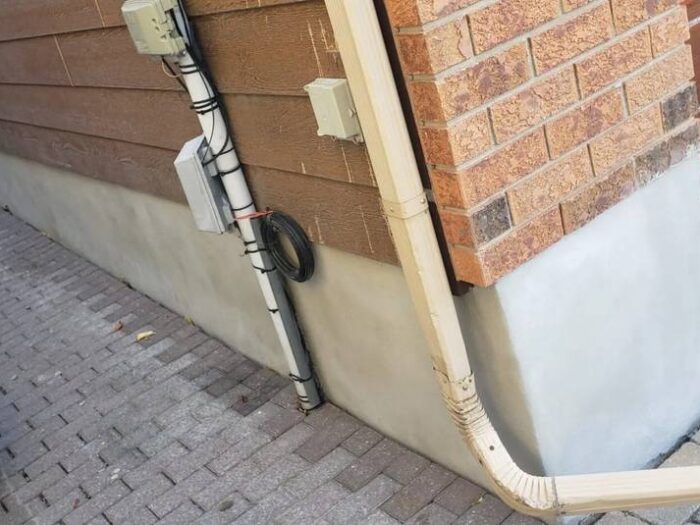 Parged wall under vinyl siding