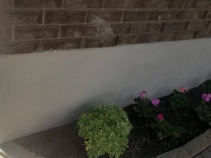 Finished parging along the exposed foundation of an Ottawa home