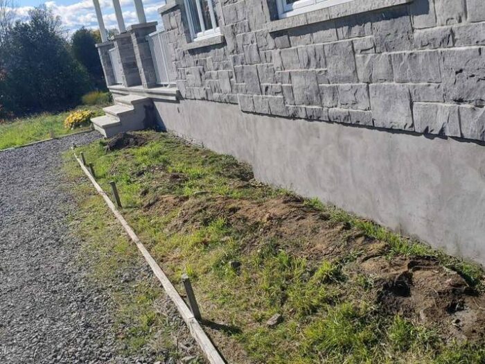 Parged foundation running the length of a house
