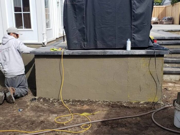 Parged wall under vinyl siding