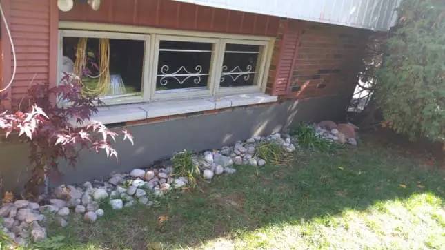 Foundation wall refinished with a fresh parging coat