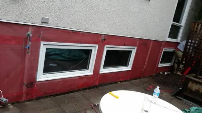 Parged foundation running the length of a house