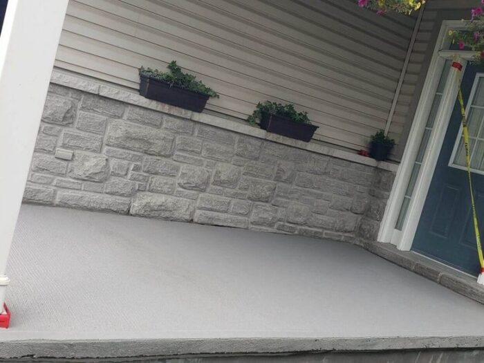 Resurfaced concrete walkway alongside a house