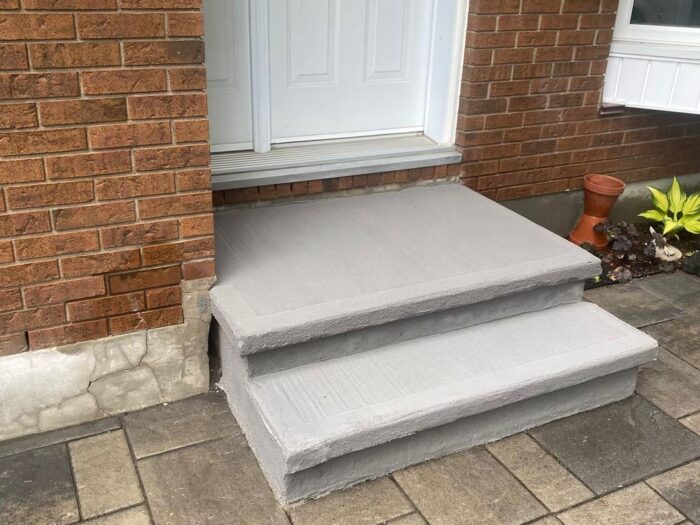 Resurfaced concrete steps at a brick home