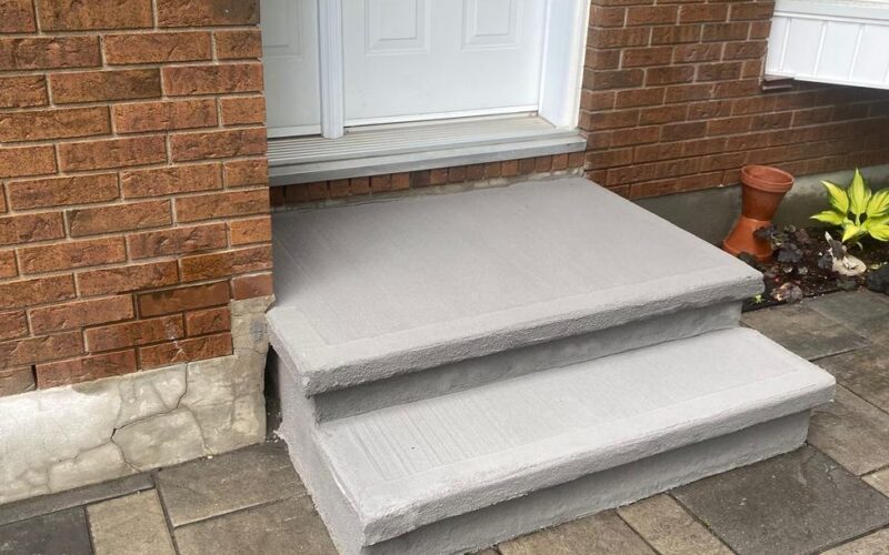 Resurfaced concrete steps at a brick home