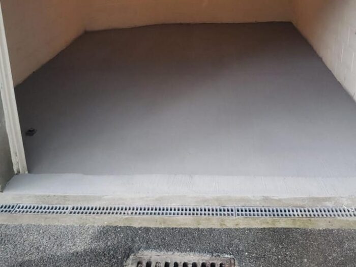 Resurfaced garage floor with a finished drainage channel