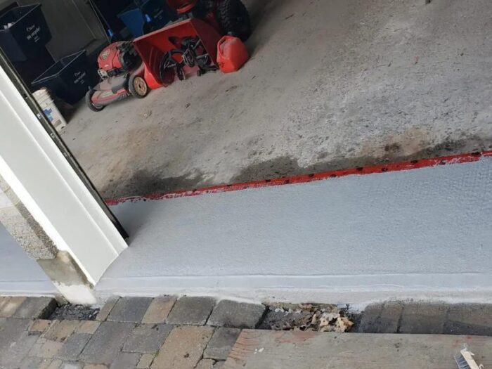 Resurfaced concrete landing at a side door