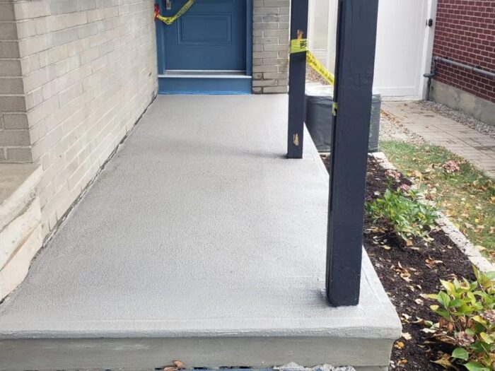 Resurfaced porch floor under a covered entrance