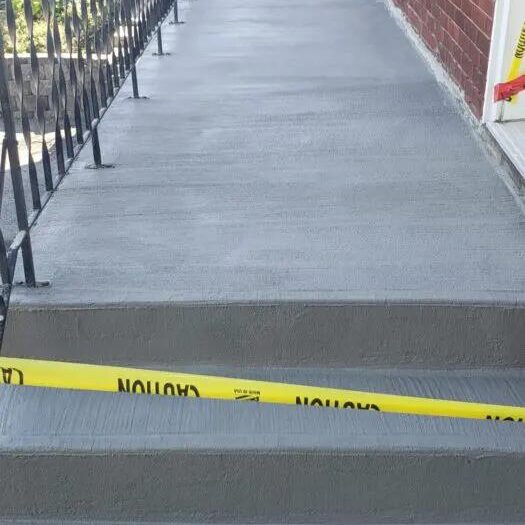 Resurfaced walkway masked to a clean edge
