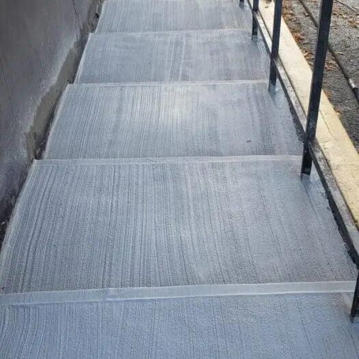 Resurfaced steps and landing with a railing