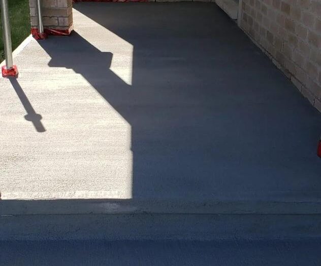Resurfaced driveway apron beside the garage