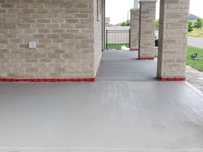 Resurfaced driveway apron at a garage