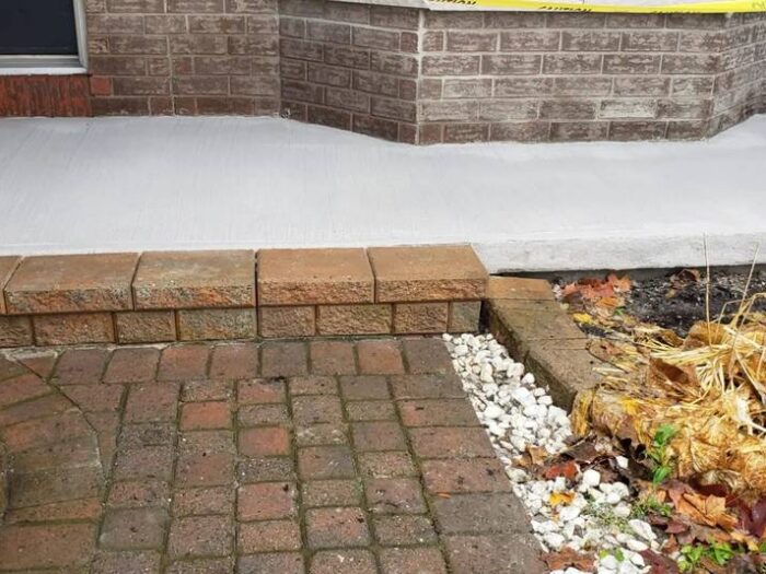 Concrete walkway resurfaced beside a house