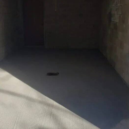 Resurfaced porch floor under a covered entrance