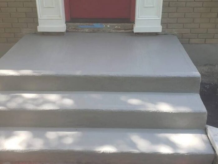 Spalled concrete covered with a new durable surface