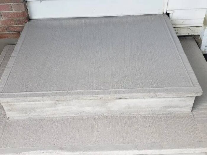 Resurfaced steps and landing at a brick home