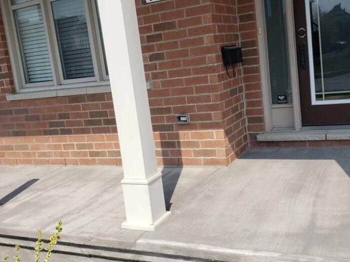Resurfaced driveway apron at a garage